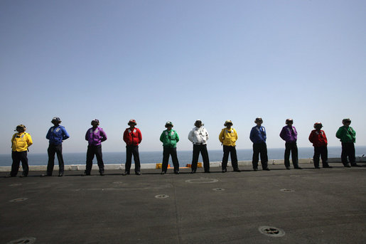 Crew members of the USS John C. Stennis stand on the deck, Friday, May 11, 2007 during Vice President Dick Cheney's arrival to the aircraft carrier. White House photo by David Bohrer