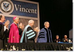 President George W. Bush is applauded by Saint Vincent College President Jim Towey, center, and Washington Archbishop Donald Wuerl as he is introduced on stage Friday, May 11, 2007, prior to delivering the commencement address at Saint Vincent College in Latrobe, Pa. White House photo by Joyce N. Boghosian