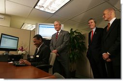 President George W. Bush is joined by Secretary Michael Chertoff, right, of the Department of Homeland Security, and Secretary Carlos Gutierrez of the Department of Commerce, as they look on during a demonstration Wednesday, May 16, 2007, of the Basic Pilot/Employment Eligibility Verification System, a voluntary program managed by U.S. Citizenship and Immigration Services that allows employers to electronically verify the eligibility of newly hired employees. The demonstration, led by Glenda Wooten-Ingram, Director of Human Resources, was held at the Embassy Suites Washington, D.C.-Convention Center, and was followed by a roundtable discussion of the program. White House photo by Joyce N. Boghosian