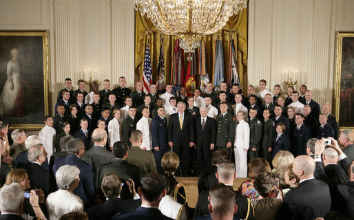 President George W. Bush and U.S. Secretary of Defense Robert Gates pose for a group photo at the commissioning ceremony for Joint Reserve Officer Training Corps Thursday, May 17, 2007, in the East Room of the White House. White House photo by Joyce Boghosian