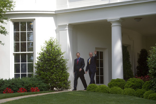 President George W. Bush and Prime Minister Tony Blair of the United Kingdom wave to the press from the Oval Office Wednesday, May 17, 2007. White House photo by Joyce Boghosian