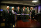 President George W. Bush looks to Martin Gross, Project Manager for the White House Situation Room, as he prepares to cut the ribbon during a ceremony Friday, May 18, 2007, in the newly renovated facility. Joining in the ceremony are, from left: Phil Lago, Executive Secretary, National Security Council; Vice President Dick Cheney; Gary Bresnahan, Deputy Director, Systems and Technical Planning; President Bush, Martin Gross, and Jeff Foltz, Senior Project Manager, White House Military Office. White House photo by Eric Draper