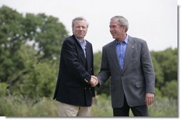 President George W. Bush shakes hands with NATO Secretary General Jaap de Hoop Scheffer Monday, May 21, 2007, as the two wound up a visit to the Bush Ranch in Crawford, Texas. The President thanked the Secretary-General for his leadership and called him a "strong advocate of fighting terror, spreading freedom, helping the oppressed and modernizing this important alliance." White House photo by Shealah Craighead