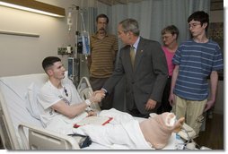 President George W. Bush shakes the hand of Cpl. Ryan T. Dion of Manchester, Conn., after awarding him a Purple Heart Thursday, May 25, 2007, during a visit to the National Naval Medical Center in Bethesda, Md., where the Marine is recovering from wounds received in Operation Iraqi Freedom. With them are Cpl. Dion's parents, Thomas and Patricia Dion, and brother, Justin. White House photo by Joyce Boghosian