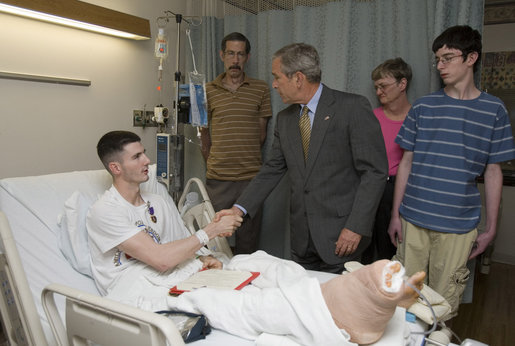 President George W. Bush shakes the hand of Cpl. Ryan T. Dion of Manchester, Conn., after awarding him a Purple Heart Thursday, May 25, 2007, during a visit to the National Naval Medical Center in Bethesda, Md., where the Marine is recovering from wounds received in Operation Iraqi Freedom. With them are Cpl. Dion's parents, Thomas and Patricia Dion, and brother, Justin. White House photo by Joyce N. Boghosian