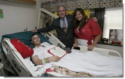 President George W. Bush stands with PFC. Arturo E. Weber and his cousin, Lisa, after awarding the Marine with a Purple Heart during a visit Friday, May 25, 2007, to the National Naval Medical Center in Bethesda, Md., where he is recovering from wounds received in Operation Iraqi Freedom.  White House photo by Joyce Boghosian