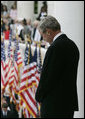 President George W. Bush bows his head during the reading of the invocation at the Memorial Day ceremony Monday, May 28, 2007, at Arlington National Cemetery in Arlington, Va. Addressing the gathered audience President Bush said, “The greatest memorial to our fallen troops cannot be found in the words we say or the places we gather. The more lasting tribute is all around us—a country where citizens have the right to worship as they want, to march for what they believe, and to say what they think.” White House photo by Joyce Boghosian