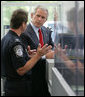 President George W. Bush listens to Ty Bowers, Assistant Director of U.S. Customs and Border Protection, as he demonstrate how people are screened at primary and secondary locations Tuesday, May 29, 2007, during a tour of the Federal Law Enforcement Training Center in Glynco, Ga. White House photo by Eric Draper