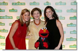 Mrs. Laura Bush is joined by her daughters Jenna Bush, left, and Barbara Bush, as they pose for a photo with Sesame Street character Elmo Wednesday evening, May 30, 2007, at the Sesame Workshop Fifth Annual Benefit Dinner in New York, where Mrs. Bush was honored for her commitment to literacy and education.  White House photo by Shealah Craighead