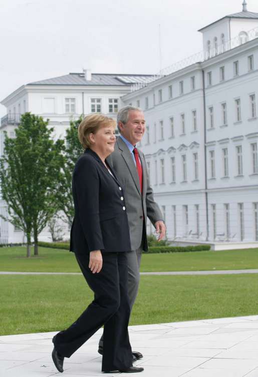 President George W. Bush walks with Germany's Chancellor Angela Merkel as the two leaders met for lunch Wednesday, June 6, 2007, at the Kempinski Grand Hotel in Heiligendamm, Germany. White House photo by Eric Draper