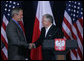 President George W. Bush and President Lech Kaczynski of Poland, shake hands at the conclusion of their joint statement Friday, June 8, 2007, at Gdansk Lech Walesa International Airport in Gdansk. White House photo by Chris Greenberg