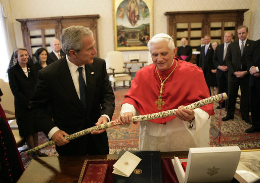 Pope Benedict XVI smiles as he holds a walking stick presented to him by President George W. Bush and Mrs. Laura Bush Saturday, June 9, 2007, during their visit to the Holy See. The walking stick, created by a former homeless Texas man, is adorned with the Ten Commandments in multiple colors. White House photo by Eric Draper