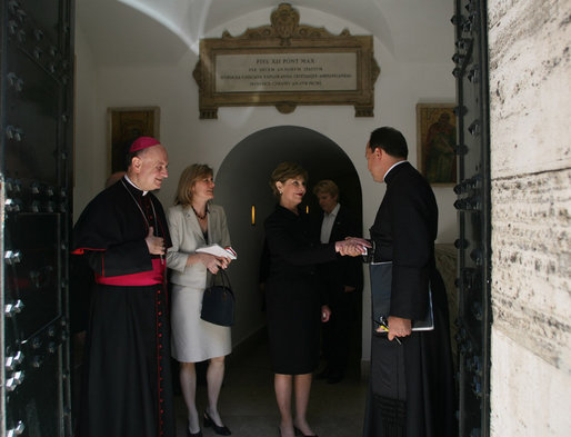Mrs. Laura Bush shakes the hand of a Vatican official after visiting the tomb of Pope John Paul II Saturday, June 9, 2007, in Rome. White House photo by Shealah Craighead