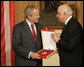 President George W. Bush accepts the Order of the National Flag Award from President Alfred Moisiu of Albania Sunday, June 10, 2007, during arrival ceremonies in Tirana welcoming the President and Mrs. Bush to the country. White House photo by Eric Draper