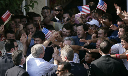 President George W. Bush reaches into a U.S. flag-waving crowd in Fushe Kruje, Albania Sunday, June 10, 2007, as hundreds of townspeople turned out to celebrate the first visit by a U.S. president to their country. White House photo by Shealah Craighead