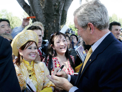 President George W. Bush signs autographs following his speech Tuesday, June 12, 2007, at the dedication ceremony for the Victims of Communism Memorial in Washington, D.C. White House photo by Joyce N. Boghosian