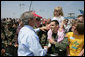 President George W. Bush greets Boeing employees and military base personnel and families after arriving Friday, June 15, 2007, at McConnell Air Force Base in Wichita. More than 1500 people were on hand to greet the President, who told them, " I'm honored to be here with Senator Pat Roberts and Vicki Tiahrt. They're strong supporters of the programs here, strong supporters of Boeing. I appreciate you coming out to say hello." White House photo by Eric Draper