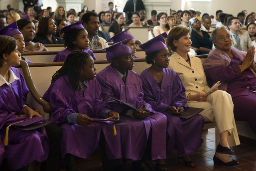 Mrs. Laura Bush sits with sixth-grade of the Elsie Whitlow Stokes Community Freedom Public Charter School graduates during ceremony marking their accomplishment Friday, June 15, 2007, at All Souls Unitarian Church in Washington, D.C. "Keep caring for the community," said Mrs. Bush in her commencement address. "Be good stewards of our environment, as you were when you helped clean up the Potomac River at Hard Bargain Farm." White House photo by Shealah Craighead
