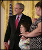 President George W. Bush embraces stem cell patient Kaitlyne McNamara following his address on the reasons he vetoed S.5, the “Stem Cell Research Enhancement Act of 2007,” in the East Room of the White House Wednesday, June 20, 2007. McNamara was born with spina bifida, a disease that damaged her bladder, her doctors isolated healthy stem cells in a piece of her own bladder and used them to grow her a new bladder. White House photo by Eric Draper
