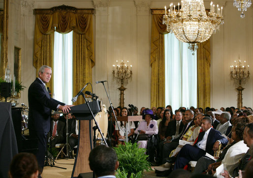 President George W. Bush welcomes guests to the East Room of the White House Friday, June 22, 2007, to join in a celebration of Black Music Month, focusing on the music of hip hop and R &B artists. White House photo by Chris Greenberg