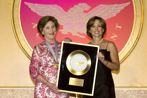 Dorothy Hamill, 1976 US Gold Medal Olympic Champion, presents Mrs.Laura Bush the Academy of Achievement Golden Plate Award Friday, June 22, 2007, during a ceremony in Washington, D.C. Mrs. Bush was presented the award for her achievements in Public Service, Friday, June 22, 2007. President George H.W. Bush received the Golden Plate Award in 1995. White House photo by Shealah Craighead
