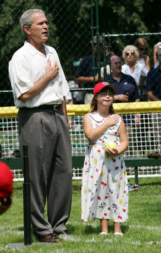President George W. Bush is joined for the singing of the national anthem by Meredith Cripe, a member of the Chantilly, Virginia Little League Challenger League, at the top of the first White House Tee Ball Game of the 2007 season. The game pitted the Bobcats from Cumberland, Maryland, against the Red Wings of Luray, Virginia. White House photo by Eric Draper