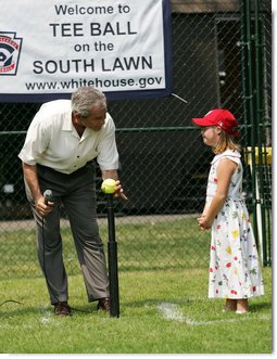 Under the watchful eye of Meredith Cripe, a member of the Chantilly, Virginia Little League Challenger League, President George W. Bush places a ball on the tee to start the game and the 2007 White House Tee Ball Season on the South Lawn. The game pitted the Bobcats from Cumberland, Maryland, against the Red Wings of Luray, Virginia. White House photo by Eric Draper