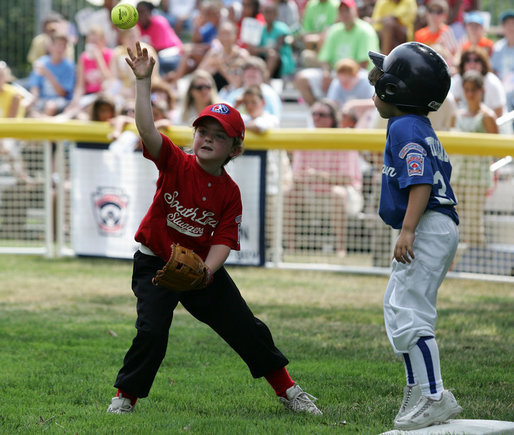 It's safe at first for a Cumberland Bobcat as the Red Wings' first baseman returns the ball to the catcher Wednesday, June 27, 2007, during the first game of the 2007 White House Tee Ball season on the South Lawn. The game pitted the Luray, Virginia team against the Cumberland, Maryland kids, and marked the seventh year of the President's White House Tee Ball Initiative. White House photo by Eric Draper