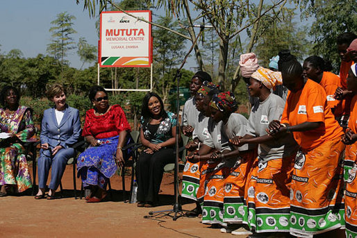 Mrs. Laura Bush is greeted a by a chorus of singers as she joins her fellow participants at the Mututa Memorial Center Thursday, June 28, 2007, in Lusaka, Zambia. Pictured are from left: Mrs. Martha Chilufya, Director of the Mututa Memorial Center; Maureen Mwanawasa, First Lady of Zambia, and Melinda Doolittle, American Idol finalist. White House photo by Lynden Steele