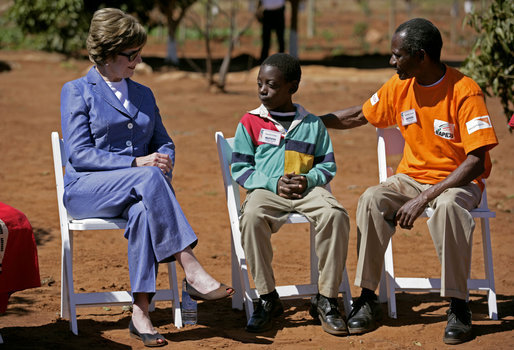 Mrs. Laura Bush talks with Raphael Lungo, 10, during a discussion with caregivers and beneficiaries of the Mututa Memorial Center Thursday, June 28, 2007 in Lusaka, Zambia. The center provides many humanitarian services including home-based care for people living with HIV/AIDS, care for orphans and promotes abstinence and faith for youth. White House photo by Shealah Craighead