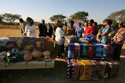 At the Flame Community Center in Lusaka, Zambia, Mrs. Laura Bush, Ms. Jenna Bush and Zambian First Lady Mrs. Maureen Manawasa visit a marketplace demonstrating small enterprises begun with the help of WORTH, a program that trains women in literacy, group savings, peer lending and small business development. White House photo by Shealah Craighead