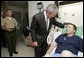 As a Military Aide to the President reads the citation, President George W. Bush honors Sgt. 1st Class Andy Allen with a Purple Heart Tuesday, July 3, 2007, during a visit to Walter Reed Army Medical Center in Washington, D.C., where the Elk City, O.K., soldier is recovering from wounds received in Operation Iraqi Freedom. White House photo by Eric Draper