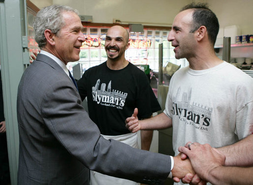 President George W. Bush is greeted by Samir Elnahass, center, and his cousin Freddie Slyman, on his arrival to Slyman’s Restaurant in Cleveland, Ohio, Tuesday, July 10, 2007, where President Bush attended a luncheon with community leaders. White House photo by Chris Greenberg