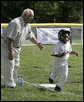 Hall of Fame baseball manager Tommy Lasorda urges on a player from the Wrigley Little League Dodgers of Los Angeles, as he runs for home against the Inner City Little League of Brooklyn, N.Y., Sunday, July 15, 2007, during the White House Tee Ball Game celebrating the legacy of Jackie Robinson on the South Lawn of the White House. Brooklyn and Los Angeles represent the two home cities of Robinson’s team. More about Tee Ball on the South Lawn. White House photo by Joyce N. Boghosian