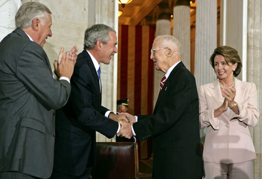President George W. Bush congratulates Dr. Norman Bourlag during the Congressional Gold Medal Ceremony honoring the doctor's efforts to combat hunger Tuesday, July 17 , 2007, at the U.S. Capitol. Also pictured is House Majority Leader Steny Hoyer, left, and Speaker of the House Nancy Pelosi. White House photo by Chris Greenberg