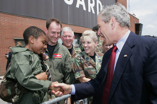 President George W. Bush introduces himself to a young child Thursday, July 19, 2007, at the Tennessee Air National Guard base in Nashville, Tenn., prior to his departure back to Washington, D.C., following a visit to the Nashville Bun Company and a speech at the Gaylord Opryland Resort and Convention Center. White House photo by Chris Greenberg