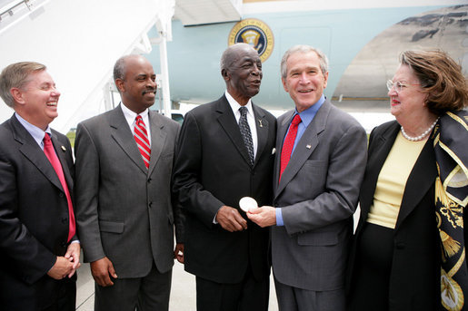 President George W. Bush presents the Congressional Gold Medal to Tuskegee Airman Earl Middleton Tuesday, July 24, 2007, joined by Middleton’s son, Kenny; South Carolina Senator Lindsey Graham, left, and Middleton family friend Joy Barnes, right, at the Charleston AFB in Charleston, S.C. White House photo by Eric Draper