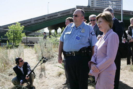 Mrs. Laura Bush surveys the wreckage of the I-35W bridge collapse with Deputy Chief of Police Robert 'Rob' Allen in Minneapolis, Friday,Aug. 3, 2007. Mrs. Bush also visited an Emergency Operation Command Center and met with volunteers and first responders. White House photo by Chris Greenberg