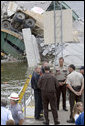 President George W. Bush talks with rescue workers and local and state law enforcement officials during a tour of the Interstate 35W bridge collapse scene in Minneapolis, Saturday, Aug. 4, 2007, where President Bush praised the work of first responders, local authorities and investigators in their response to the tragic bridge collapse. White House photo by Chris Greenberg