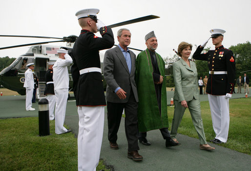 President George W. Bush and Mrs. Laura Bush walk with President Hamid Karzai of Afghanistan during an arrival ceremony at Camp David, Sunday, August 5, 2007. White House photo by Eric Draper