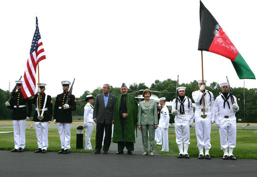 President George W. Bush and Mrs. Laura Bush stand with President Hamid Karzai of Afghanistan during an arrival ceremony at Camp David, Sunday, August 5, 2007. White House photo by Chris Greenberg