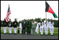 President George W. Bush and Mrs. Laura Bush stand with President Hamid Karzai of Afghanistan during an arrival ceremony at Camp David, Sunday, August 5, 2007. White House photo by Chris Greenberg