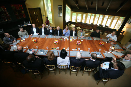 President George W. Bush meets for lunch with the Secretary of Defense, Defense Policy and Programs Team and Secretary of State and Foreign Policy Team Tuesday, Aug. 7, 2007, at Camp David. Of those photographed, Vice President Dick Cheney is seated at the President's right, Defense Secretary Robert Gates and State Secretary Condoleezza Rice are seated in front of the President. White House photo by Eric Draper