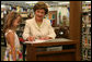 Five-year-old Reese, granddaughter of the head librarian, watches as Mrs. Laura Bush signs the children's book, 