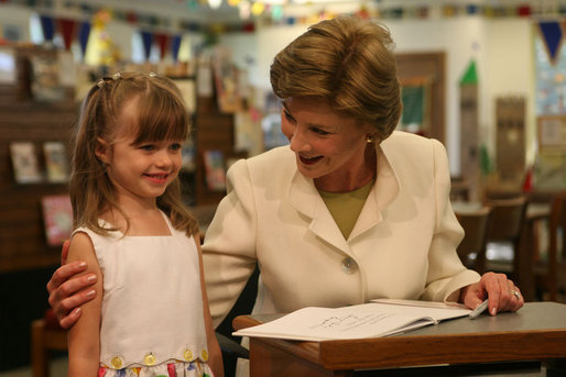 Five-year-old Reese stands with Mrs. Laura Bush at the Westbank Community Library in Austin during the announcement Tuesday, Aug. 14, 2007, of the Laura Bush Community Library. The library is the first public library in the United States to be named for Mrs. Bush, a former teacher and librarian. White House photo by Shealah Craighead