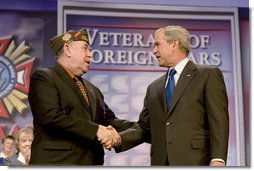 President George W. Bush shakes hands with Veterans of Foreign Wars National Commander Gary Kurpius following the President's address Wednesday, Aug. 22, 2007, to the Veterans of Foreign Wars National Convention in Kansas City, Mo. White House photo by Chris Greenberg