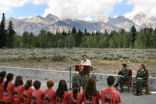 Mrs. Laura Bush speaks to Junior Ranger participants during her visit to Grand Teton National Park Aug. 27, 2007, in Moose, Wyo. "Children here can go back to the prehistoric era at Fossil Butte National Monument, where the remains of fish and insects, snails, turtles, birds, bats and plants are preserved in 50-million-year-old layers of rock," said Mrs. Bush in her address. "Young people can discover the stories of their ancestors, the American pioneers, who migrated west along the Oregon Trail at the Fort Laramie National Area." White House photo by Shealah Craighead