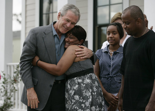 President George W. Bush is embraced by homeowner Gen White as members of her family look on, Wednesday, Aug. 29, 2007, following the President's visit to her new home in New Orleans. White House photo by Shealah Craighead