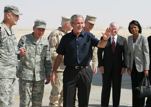 President George W. Bush waves after arriving at Al Asad Airbase, Al Anbar Province, Iraq, Monday, September 3, 2007. The greeting party from left are Lieutenant General Raymond Odierno, Commanding General, Multi-National Corps, General David Petraeus, Commander, Multi-National Force Iraq, Admiral William Fallon, Commander US Central Command, General Peter Pace, Chairman of the Joint Chiefs of Staff, Secretary of Defense Robert Gates and Secretary State Condoleezza Rice. White House photo by Eric Draper
