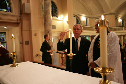 As Reverend Luis León looks on, President George W. Bush lights a candle during a service of prayer and remembrance at St. John's Episcopal Church in Washington, D.C., Tuesday, Sept.11, 2007, marking the sixth anniversary of the Sept. 11, 2001 terrorist attacks on U.S. soil. White House photo by Eric Draper